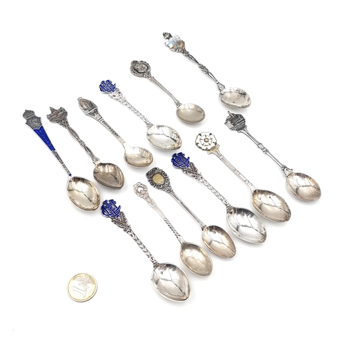 51 - A collection of twelve silver souvenir spoons with various decorative finials. Some marked Sterling,... 