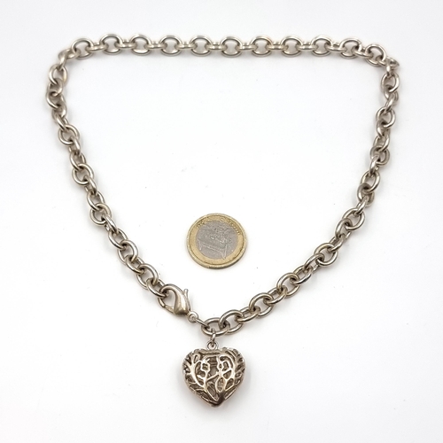 56 - A pretty sterling silver chain link necklace set with a heart shaped pendant with lattice design. Le... 