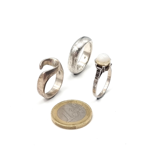 58 - A collection of silver rings. One with a pearl setting (Size - R, Weight - 3.09 grams) Together with... 