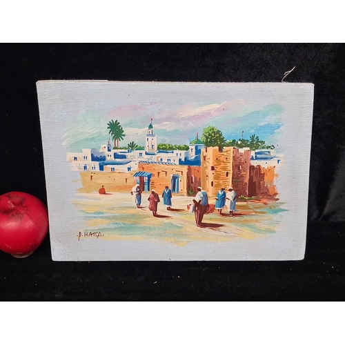 84 - A charming oil on canvas painting featuring a Moroccan townscape scene. Signed P. Hatla bottom left.