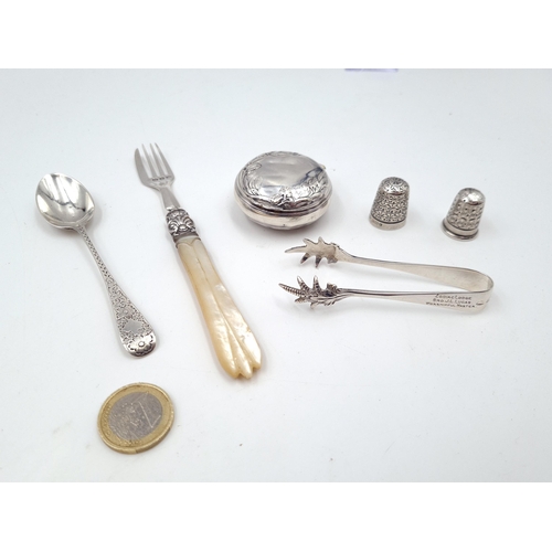 934 - Six antique and vintage silver items including two pretty 19th century thimbles, an 1890s sugar spoo... 