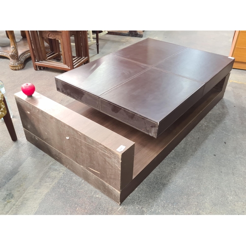 986 - A stylish and contemporary large coffee table, this high quality piece features a chocolate brown le... 