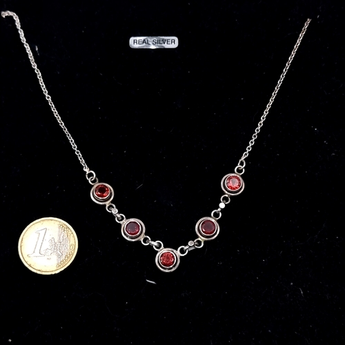 981 - A Sterling Silver and garnet necklace.