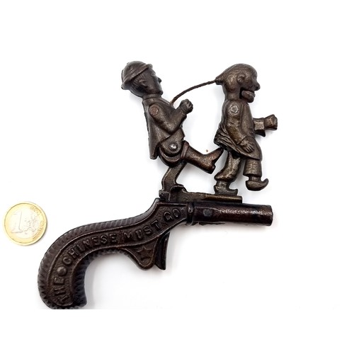 977 - An antique 19th century American cast iron cap gun. Created in the peak of Anti-Chinese sentiment an... 