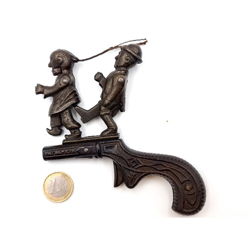 977 - An antique 19th century American cast iron cap gun. Created in the peak of Anti-Chinese sentiment an... 