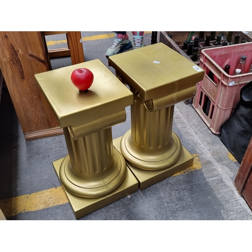 443 - Two gold toned plinths featuring ancient Roman design. Could be for busts or plant pots.