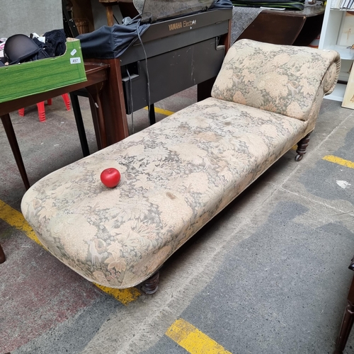 454 - A gorgeous antique  traditionally upholstered vintage chaise longue featuring turned wood legs and e... 