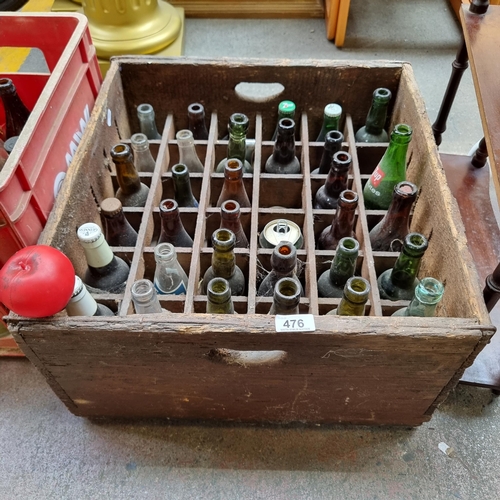 476 - A large rustic wooden crate containing a large selection of vintage glass bottles. Includes 7up, Fan... 