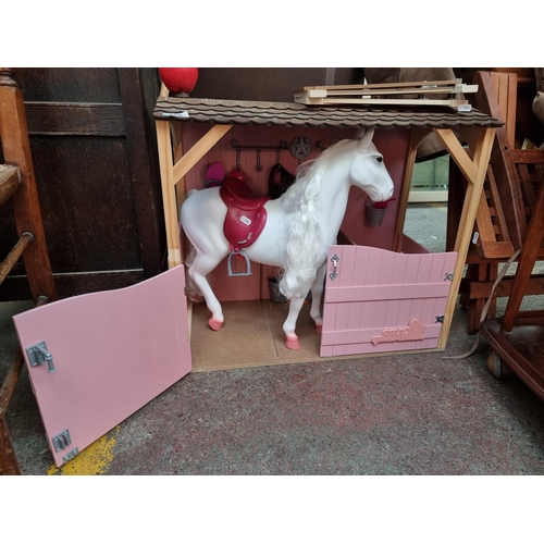 478 - An adorable childs toy stable including a majestic white horse and tree smaller hand held white poni... 