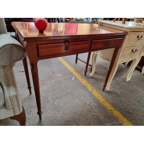 494 - An elegant tapered leg side table with brass pull handles and string inlay to top.