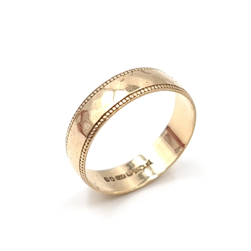 13 - An attractive nine carat gold (375) gold band ring. Ring size - N. Weight - 1.7 grams. Boxed.