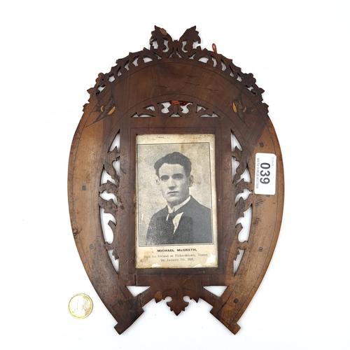 39 - An interesting wooden horseshoe mounted frame showing a memorial card for Michael McGrath. 'Died for... 