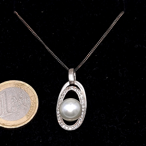 509 - A  pretty pearl mounted sterling silver pendant & chain. Length of chain - 42 cms. Boxed.