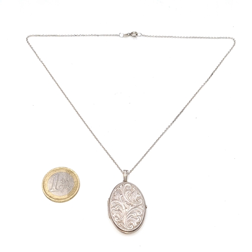 57 - A sterling silver locket pendant with foliette design. Length of chain - 40 cms. Weight - 8.2 grams.