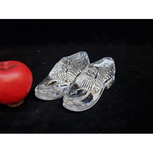 125 - Two Waterford Crystal paperweights in the form of shoes. Both in good condition with acid marks to b... 