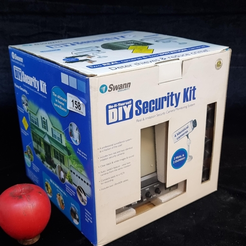 158 - A brand new in box Swann Security Kit. Contains four cameras (two real & two dummy), along with a mo... 