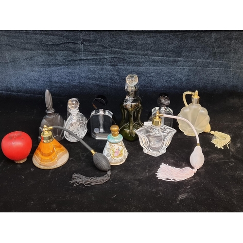 161 - A selection of nine stylish perfume bottles including two Art Deco style examples.