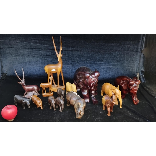 167 - A mixed lot of 14 hand carved wooden African's best known animal figurines.