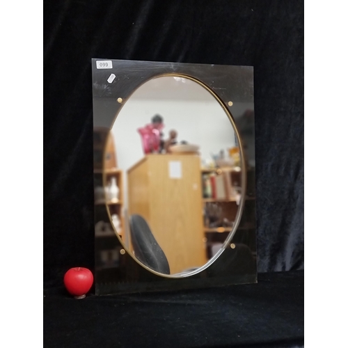 99 - A fabulous 1970's smoked lucite framed oval mirror.