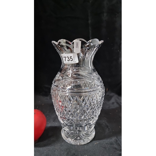 735 - A Waterford crystal cut glass vase, featuring intricate diamond patterns and a scalloped edge, marke... 