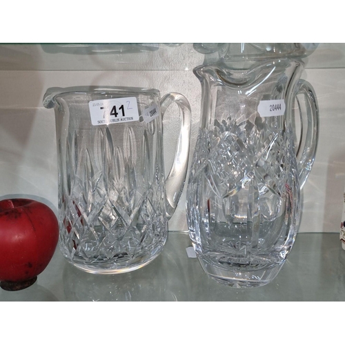 741 - Set of two Waterford crystal pitchers with intricate cut patterns.