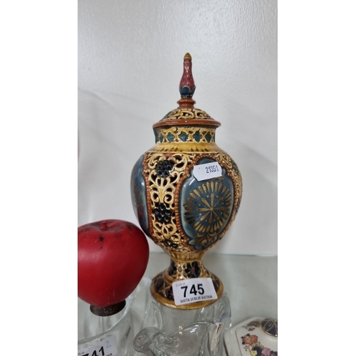 745 - A Victorian-style ceramic urn with intricate filigree design, featuring rich yellow, blue, red, and ... 