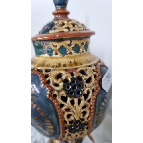 745 - A Victorian-style ceramic urn with intricate filigree design, featuring rich yellow, blue, red, and ... 