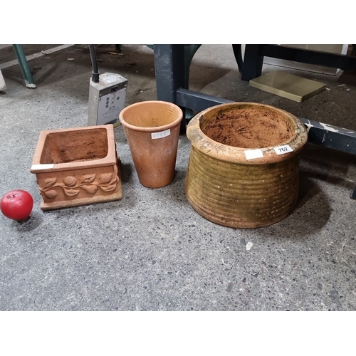 762 - Collection of three rustic terracotta planters, featuring one square and two rounded pots, ideal for... 