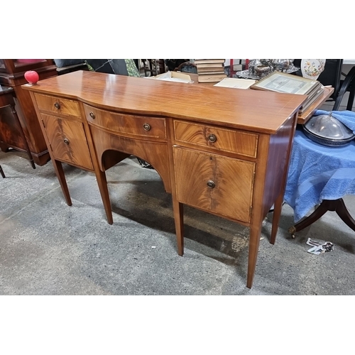 770 - Elegant mid-century modern sideboard featuring rich mahogany with multiple drawers and a sleek curva... 