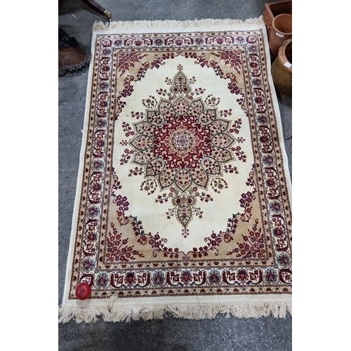 781 - Ornate Kashmir silk rug featuring intricate floral patterns and border detailing in rich reds and cr... 