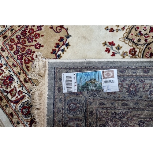 781 - Ornate Kashmir silk rug featuring intricate floral patterns and border detailing in rich reds and cr... 