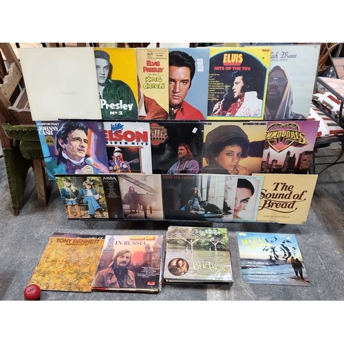 784 - Assorted collection of vintage vinyl records featuring iconic artists like Elvis Presley, Willie Nel... 