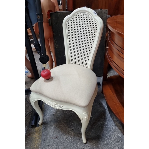 789 - Elegant antique-style chair, featuring a cream finish with intricate floral carvings and a caned bac... 