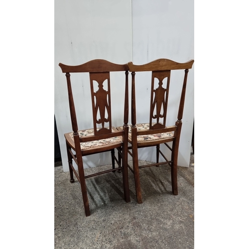 798 - Pair of early 20th century dining chairs with floral upholstered seats and elegant cut-out back desi... 