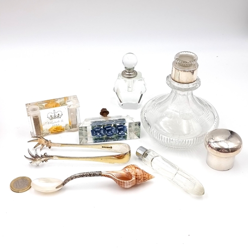 955 - An assorted collection of items consisting of a white metal topped perfume glass bottle with origina... 