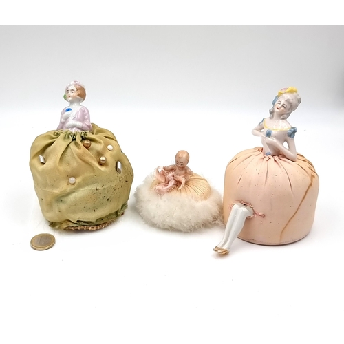 957 - A collection of antique, lovey  porcelain doll pin cushions.