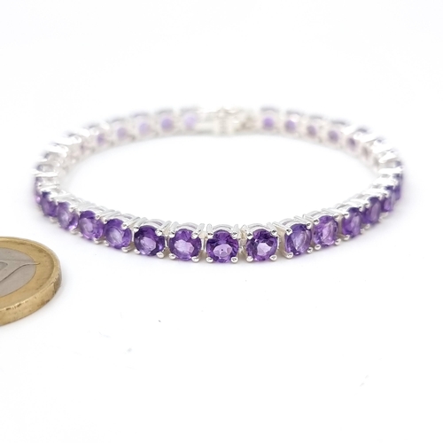 966 - Star lot : A very attractive 32 gemstone amethyst line bracelet set in sterling silver. Beautiful pi... 