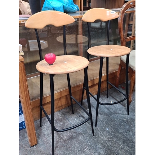 808 - Set of three contemporary bar stools featuring curved wooden seats and sleek black metal frames. Ide... 