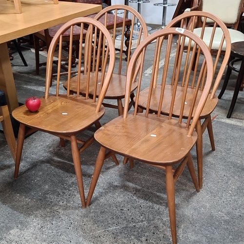 809 - Set of four vintage oak spindle-back chairs, featuring a classic mid-century modern design with curv... 