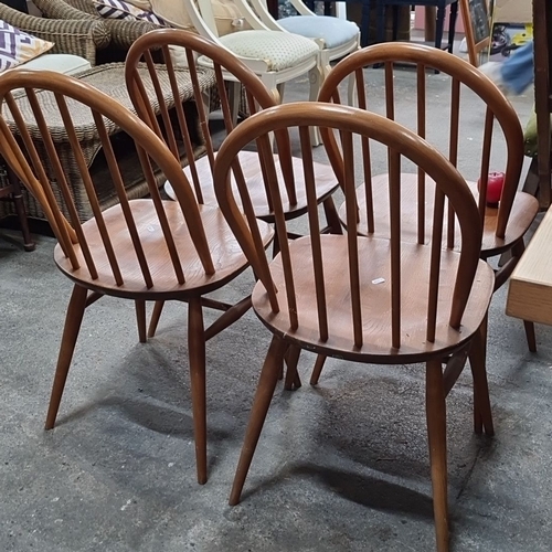 809 - Set of four vintage oak spindle-back chairs, featuring a classic mid-century modern design with curv... 