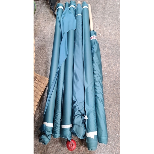 812 - Collection of large teal fabric rolls, possibly suitable for drapery or upholstery, emphasizing thei... 