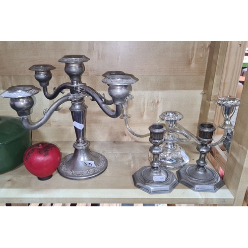 830 - Assortment of six silver-plated candlesticks, featuring elegant engraving and varied designs, suitab... 