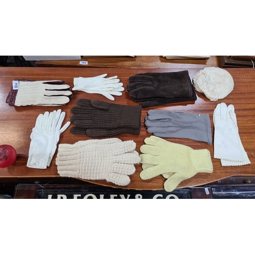 834 - Assorted collection of vintage gloves featuring various materials including leather, suede, and knit... 