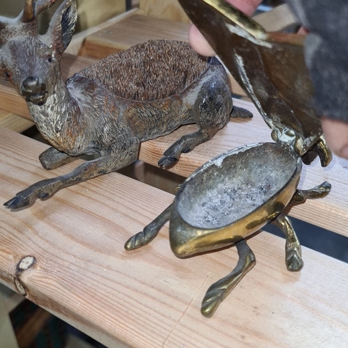 835 - This lot features a pair of intriguing metal animal figurines: one deer and one beetle. The beetle, ... 