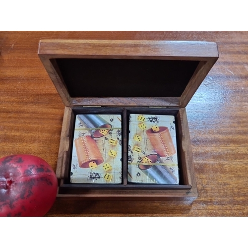 851 - Vintage wooden playing card box with decorative suit symbols on lid. Includes two packs of illustrat... 