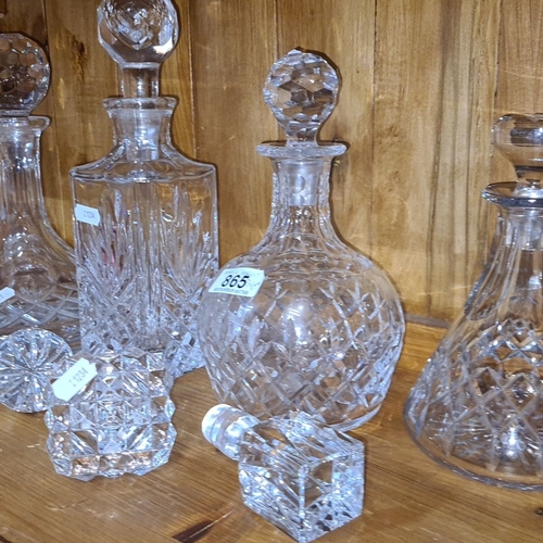 865 - Set of four intricately cut crystal decanters with faceted stoppers, showcasing classic European des... 