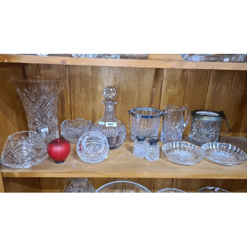 867 - Elegant collection of cut glass crystalware, featuring a decanter, assorted bowls, and serving piece... 