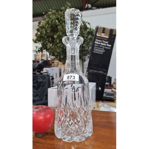 873 - Elegant crystal decanter featuring a multifaceted stopper and intricate cut design, perfect for soph... 