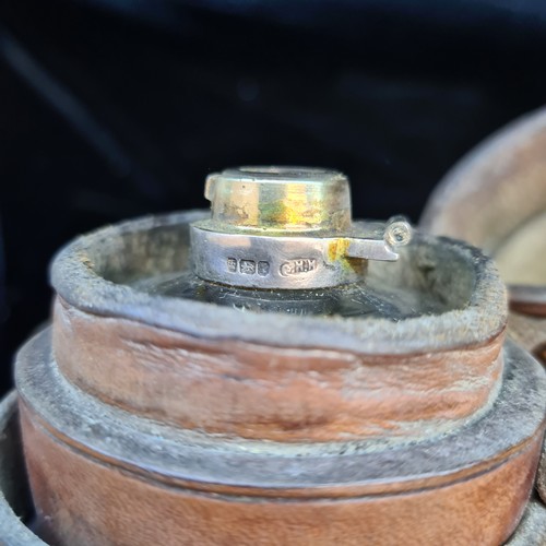 140 - An antique glass hunting saddle flask with silver collar in original brown leather case.