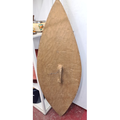 152 - Star Lot : An amazing painted ovoid African tribal sheild. With animals and masks in relief.